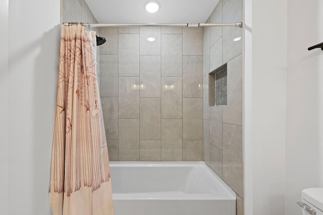 full bath with shower / bath combo with shower curtain and toilet