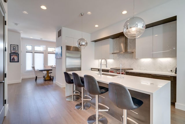 1106 Sigler St, Nashville, TN 37203 - kitchen with modern cabinets, wall chimney range hood, light countertops, tasteful backsplash, and a sink