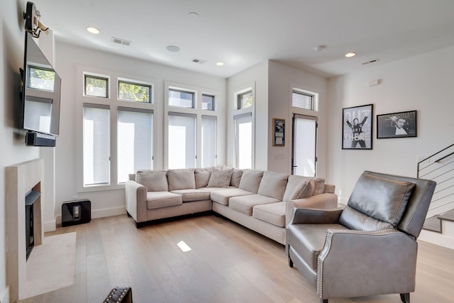 1106 Sigler St, Nashville, TN 37203 - living area with a high end fireplace, light wood finished floors, and visible vents