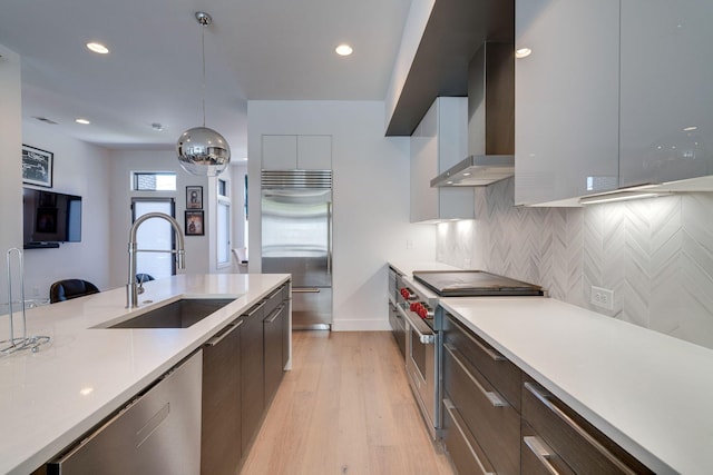 1106 Sigler St, Nashville, TN 37203 - kitchen featuring wall chimney range hood, high quality appliances, a sink, light countertops, and modern cabinets