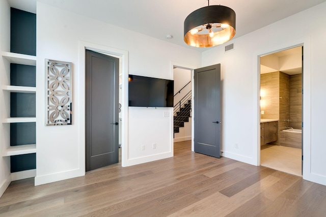 1106 Sigler St, Nashville, TN 37203 - unfurnished bedroom featuring visible vents, baseboards, ensuite bathroom, and wood finished floors
