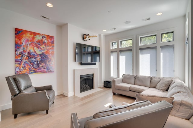 1106 Sigler St, Nashville, TN 37203 - living room with visible vents, a fireplace with flush hearth, baseboards, recessed lighting, and light wood-style flooring