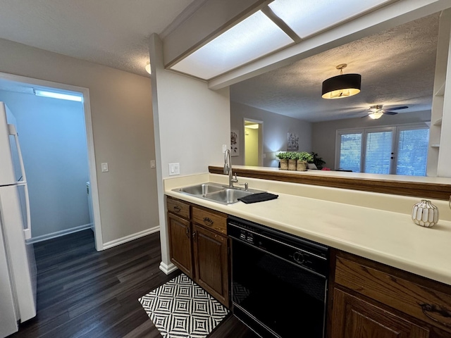 317 Village Ln W, Dickson, TN 37055 - kitchen with freestanding refrigerator, dark wood-style flooring, a textured ceiling, a sink, and dishwasher