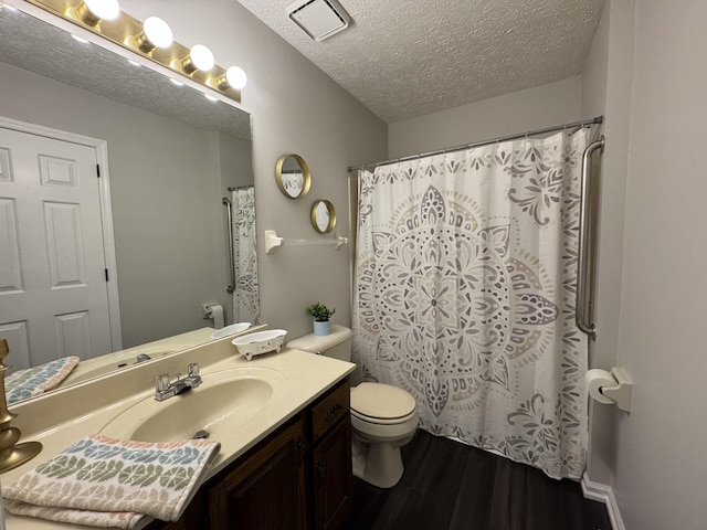 317 Village Ln W, Dickson, TN 37055 - bathroom featuring a shower with curtain, a textured ceiling, wood finished floors, vanity, and toilet