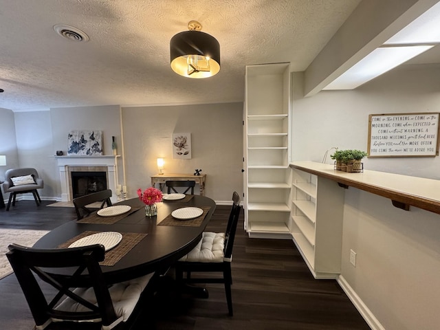 317 Village Ln W, Dickson, TN 37055 - dining space featuring dark wood-style flooring, a textured ceiling, and visible vents
