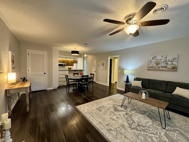 317 Village Ln W, Dickson, TN 37055 - living area with visible vents, a ceiling fan, a textured ceiling, and dark wood-style flooring