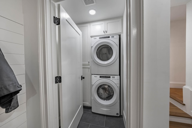 2025 Sanford Dr, Mount Juliet, TN 37122 - laundry area featuring visible vents, baseboards, stacked washing maching and dryer, and dark tile patterned flooring