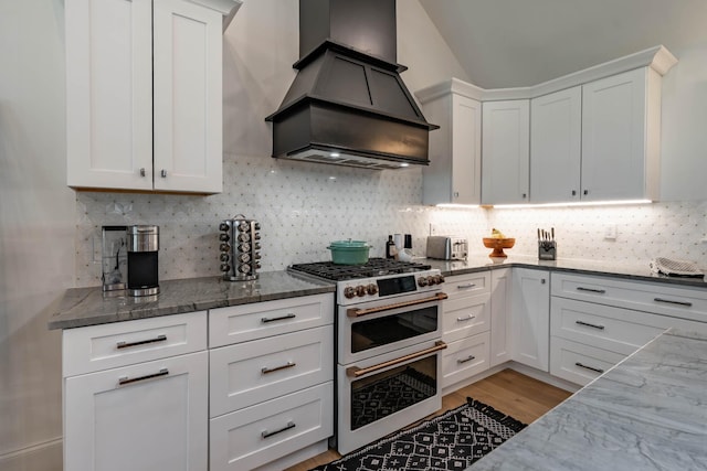 2025 Sanford Dr, Mount Juliet, TN 37122 - kitchen with double oven range, white cabinets, custom exhaust hood, dark stone counters, and light wood-style flooring