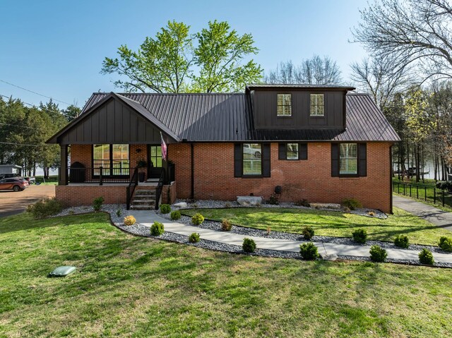 2025 Sanford Dr, Mount Juliet, TN 37122 - view of front facade featuring covered porch, a front yard, brick siding, board and batten siding, and metal roof