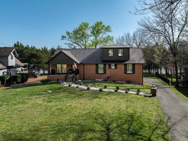 2025 Sanford Dr, Mount Juliet, TN 37122 - view of front of property with covered porch, brick siding, metal roof, and a front yard