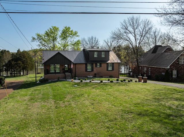 2025 Sanford Dr, Mount Juliet, TN 37122 - view of front of home featuring brick siding, metal roof, and a front lawn