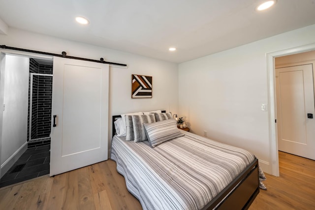 2025 Sanford Dr, Mount Juliet, TN 37122 - bedroom featuring recessed lighting, a barn door, and light wood-type flooring
