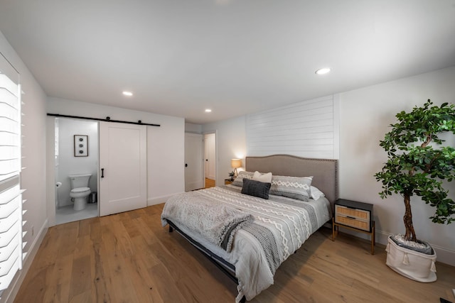 2025 Sanford Dr, Mount Juliet, TN 37122 - bedroom featuring a barn door, ensuite bath, light wood-style floors, recessed lighting, and baseboards