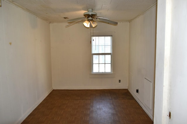 spare room featuring baseboards and ceiling fan