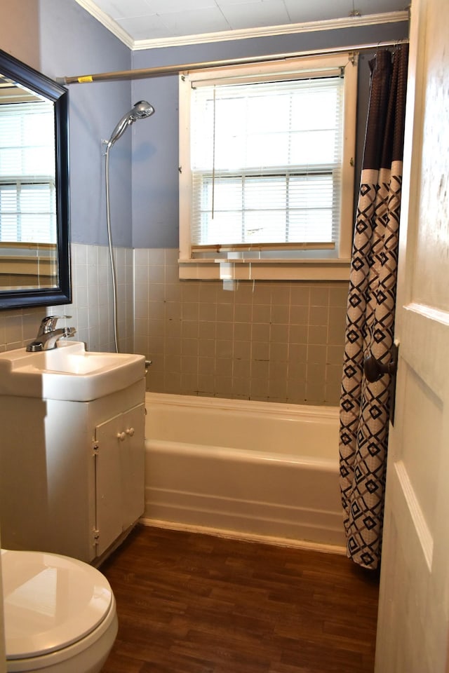 bathroom featuring vanity, shower / tub combo with curtain, wood finished floors, and ornamental molding