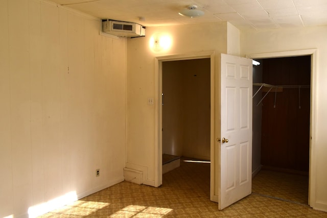 unfurnished bedroom with a closet and a spacious closet