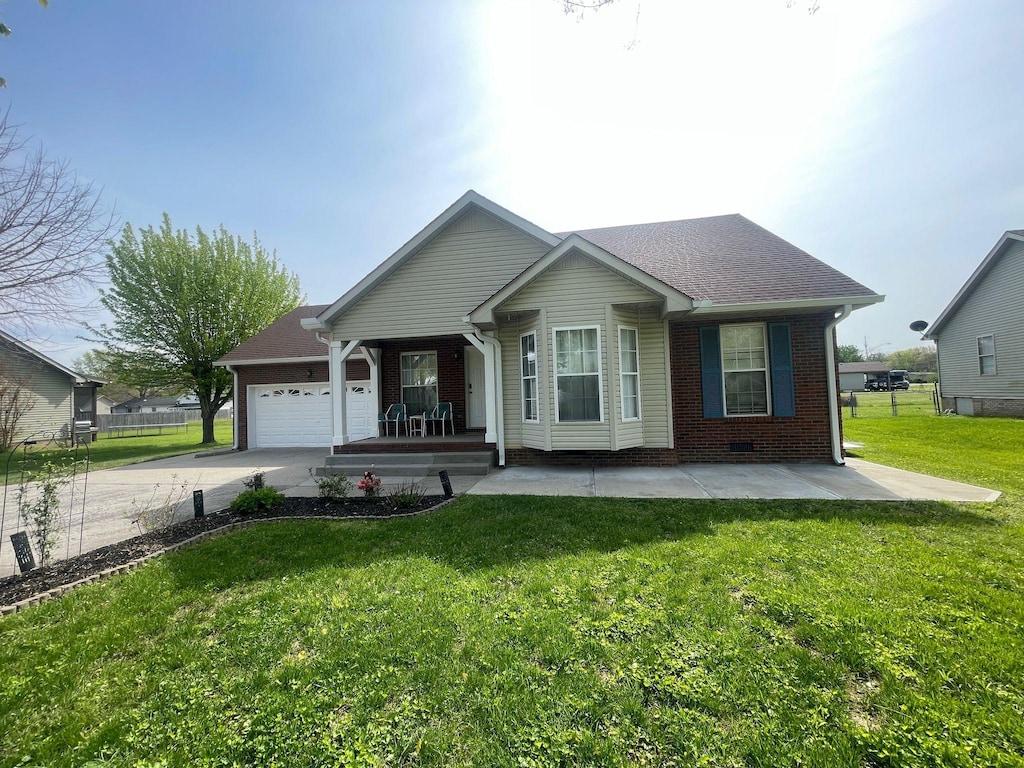 ranch-style home featuring a garage, a front lawn, covered porch, brick siding, and driveway