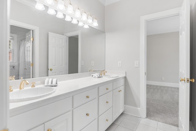 full bathroom featuring crown molding, double vanity, a sink, and tile patterned flooring
