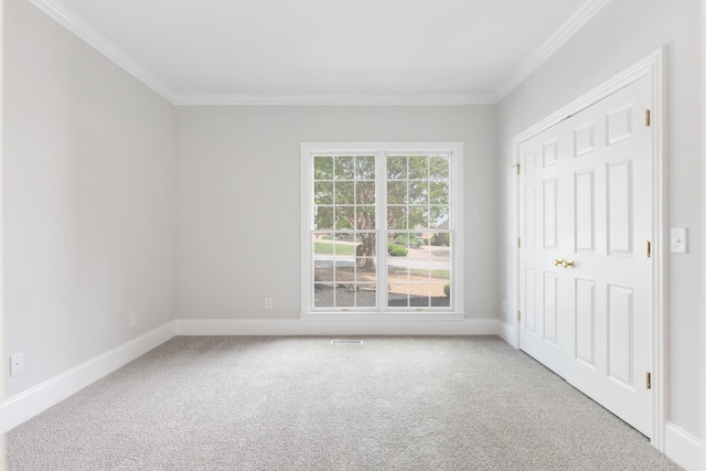 unfurnished bedroom with baseboards, ornamental molding, and carpet flooring