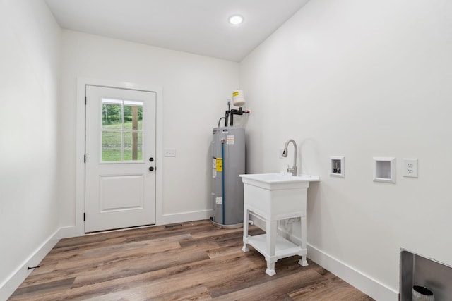 laundry area with laundry area, hookup for a washing machine, baseboards, wood finished floors, and electric water heater