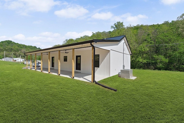 exterior space with a view of trees and central AC