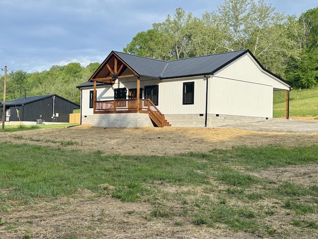 view of front facade with covered porch, crawl space, metal roof, and stairs