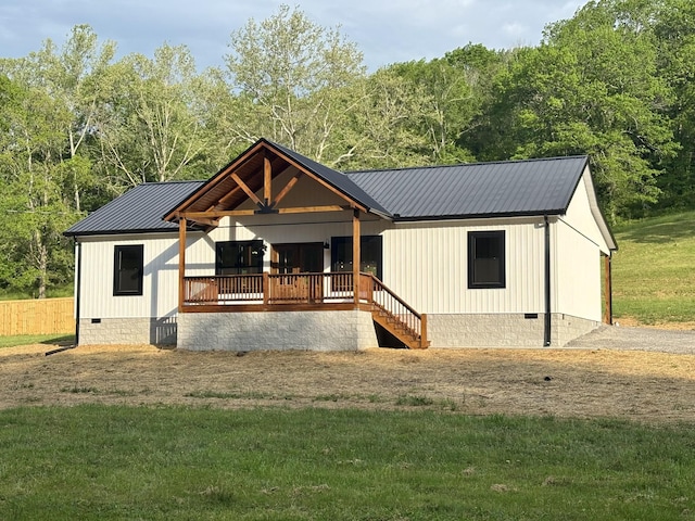modern farmhouse style home with stairway, a front yard, crawl space, and metal roof