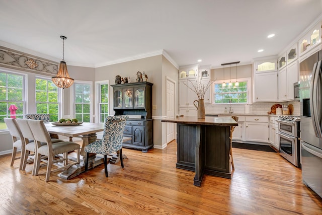 dining space featuring plenty of natural light and light wood-style flooring