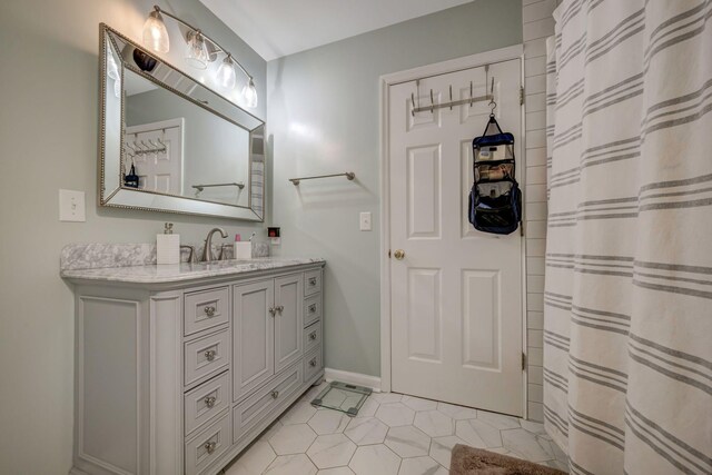 full bath featuring a shower with curtain, baseboards, tile patterned flooring, and vanity
