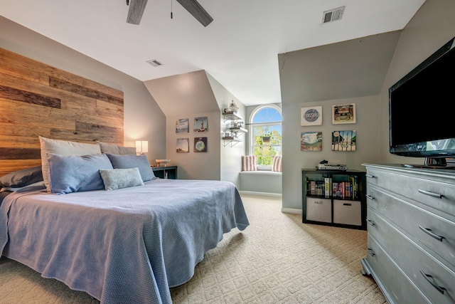 bedroom with light colored carpet, ceiling fan, vaulted ceiling, and visible vents