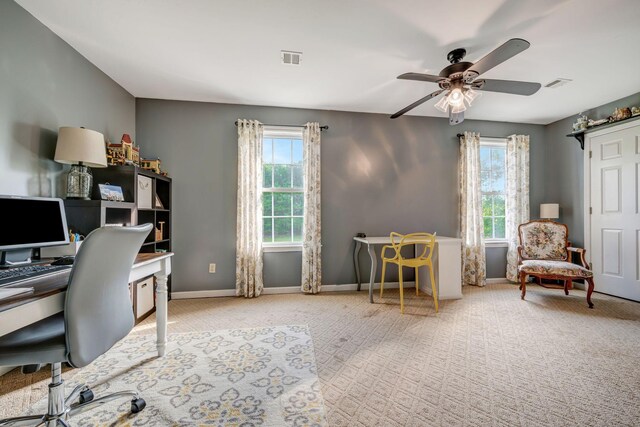 office area with visible vents, carpet flooring, baseboards, and ceiling fan