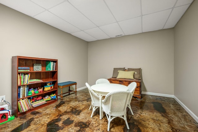 dining space featuring baseboards, a drop ceiling, and visible vents