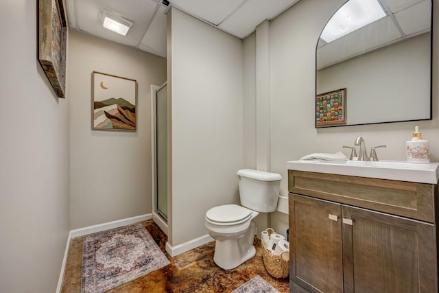 full bathroom with vanity, baseboards, a stall shower, and toilet