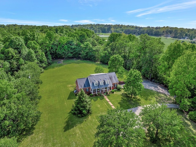 birds eye view of property featuring a view of trees