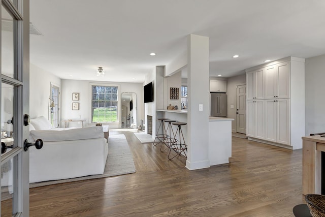 living area with recessed lighting and wood finished floors