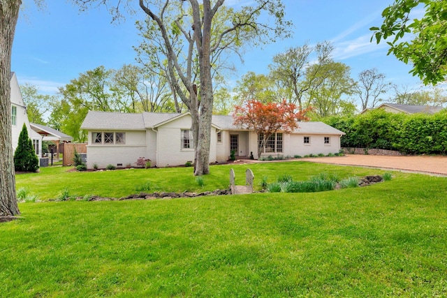 rear view of property featuring a lawn and brick siding
