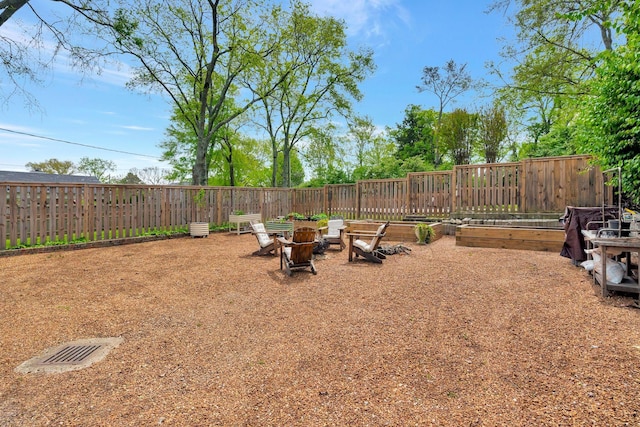 view of yard featuring a fenced backyard and an outdoor fire pit
