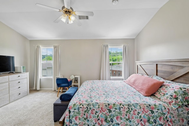 bedroom featuring carpet flooring, visible vents, multiple windows, and vaulted ceiling