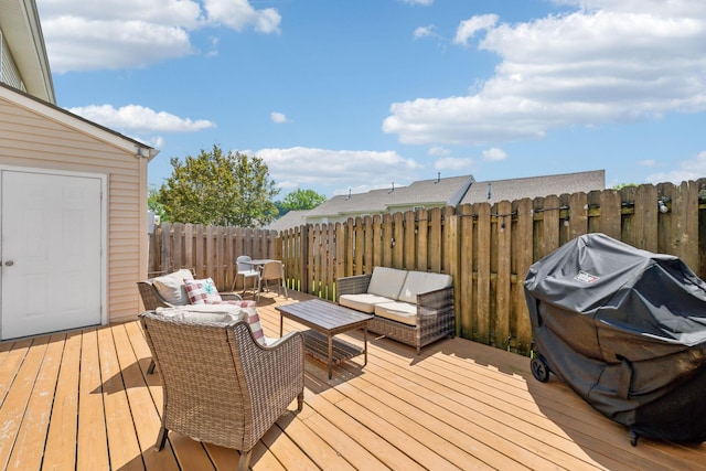 wooden terrace with an outdoor living space and fence