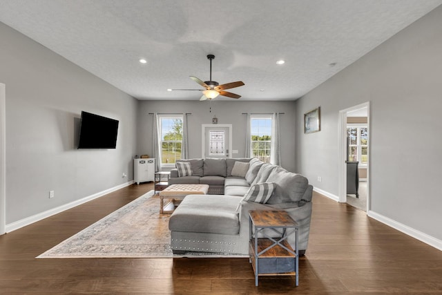 living area with baseboards, ceiling fan, and recessed lighting