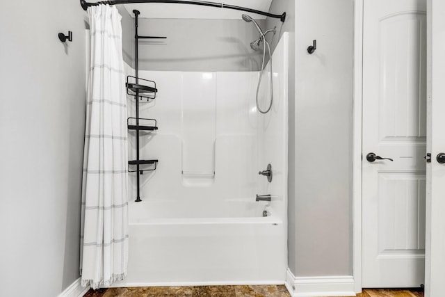 full bathroom with baseboards and shower / tub combo with curtain