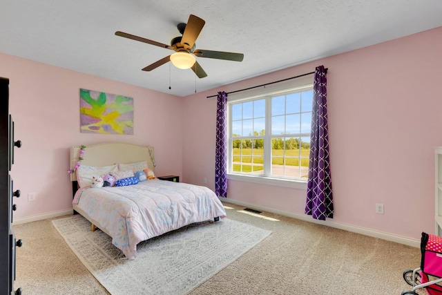 bedroom featuring baseboards, ceiling fan, and carpet flooring