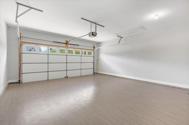 garage with baseboards and a garage door opener