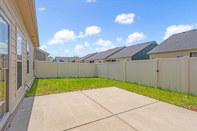view of patio featuring a fenced backyard and a residential view