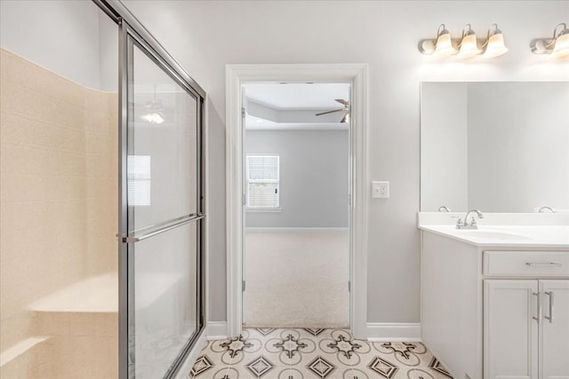 bathroom featuring baseboards, a shower with shower door, vanity, and tile patterned floors
