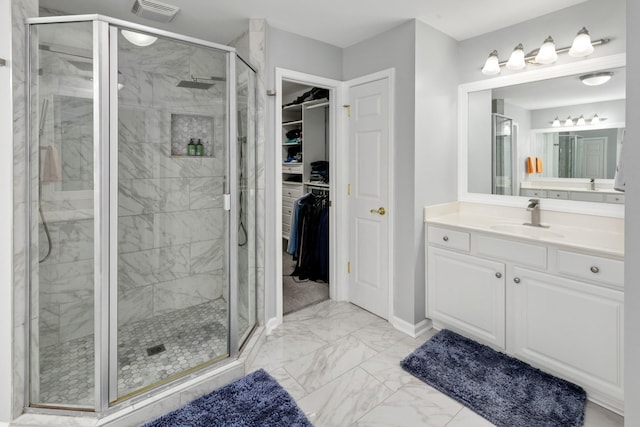 9657 Brass Valley Dr, Brentwood, TN 37027 - bathroom with a walk in closet, visible vents, a stall shower, vanity, and marble finish floor