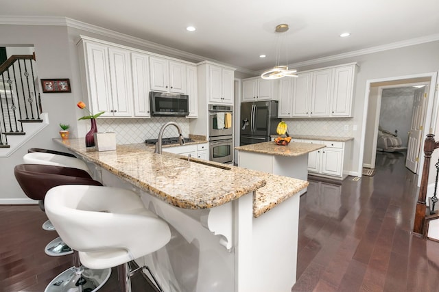 9657 Brass Valley Dr, Brentwood, TN 37027 - kitchen featuring backsplash, light stone counters, a peninsula, stainless steel appliances, and dark wood-type flooring
