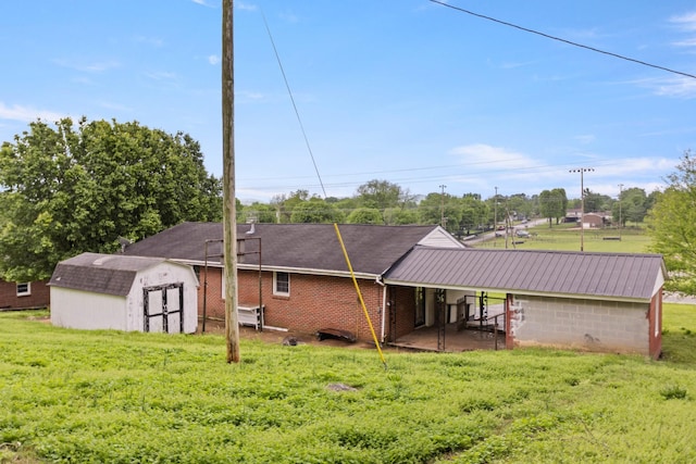 702 1st Ave, Mount Pleasant, TN 38474 - back of house with a storage shed, an outbuilding, and a yard