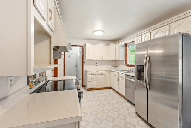 702 1st Ave, Mount Pleasant, TN 38474 - kitchen with appliances with stainless steel finishes, a sink, light countertops, white cabinetry, and light floors