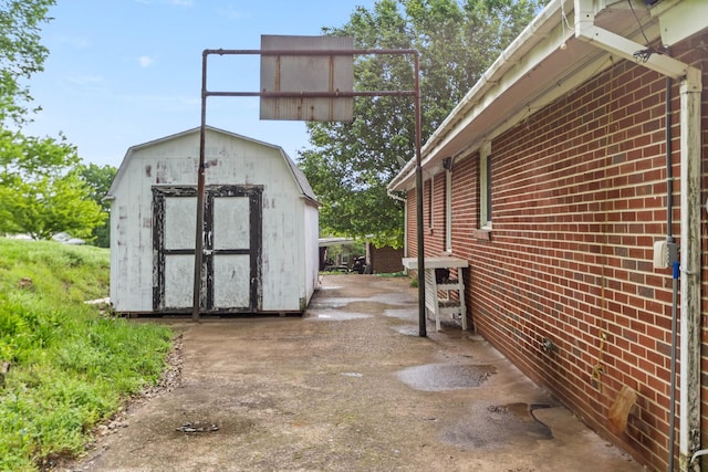 702 1st Ave, Mount Pleasant, TN 38474 - view of side of home with a storage shed, an outbuilding, and brick siding